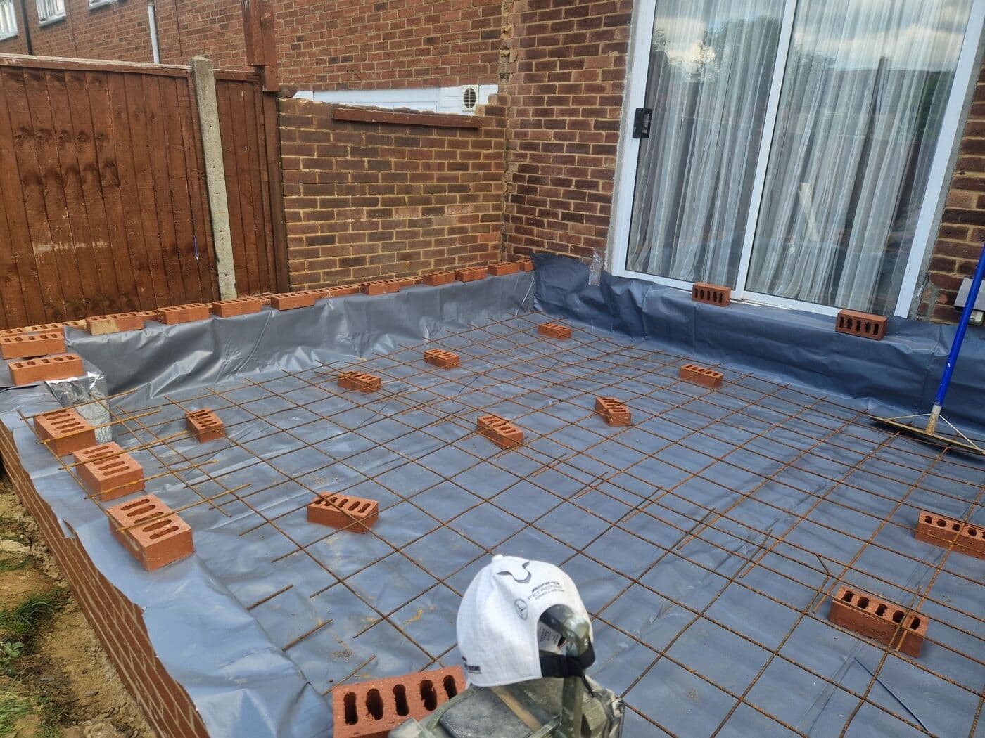 Steel reinforcement mesh over a damp-proof membrane ready for a concrete slab pour on an extension by DNR Build
