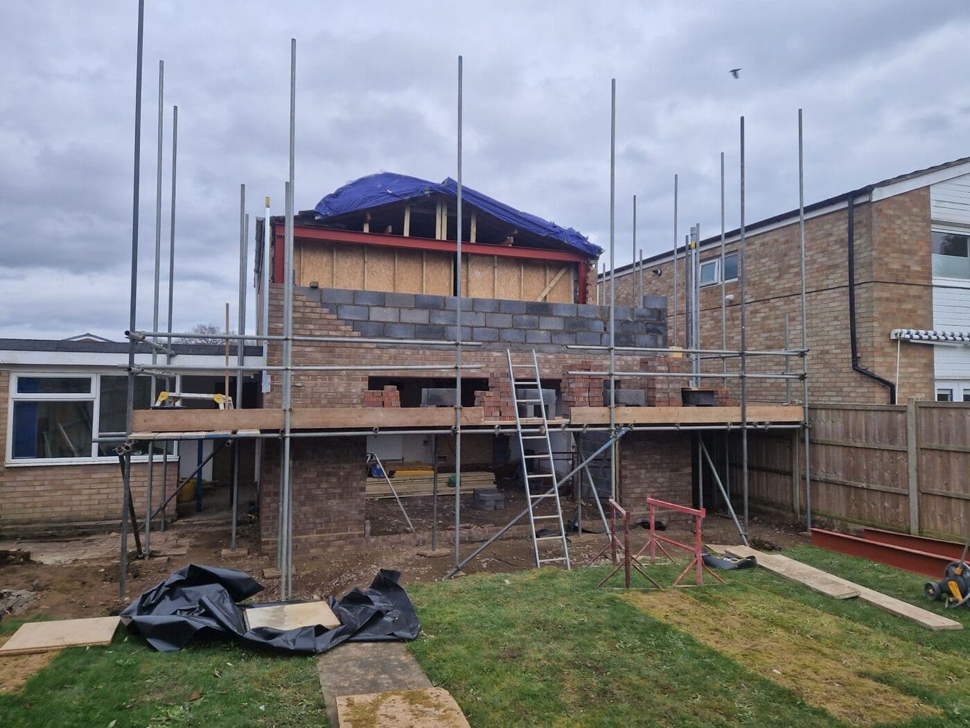 Double storey rear extension under construction with scaffolding by DNR Build